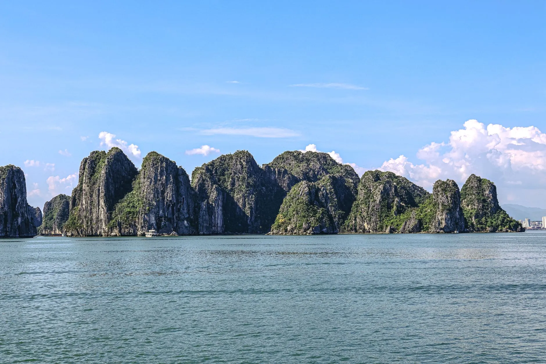 Limestone karsts of Ha Long Bay, Vietnam, under a clear blue sky