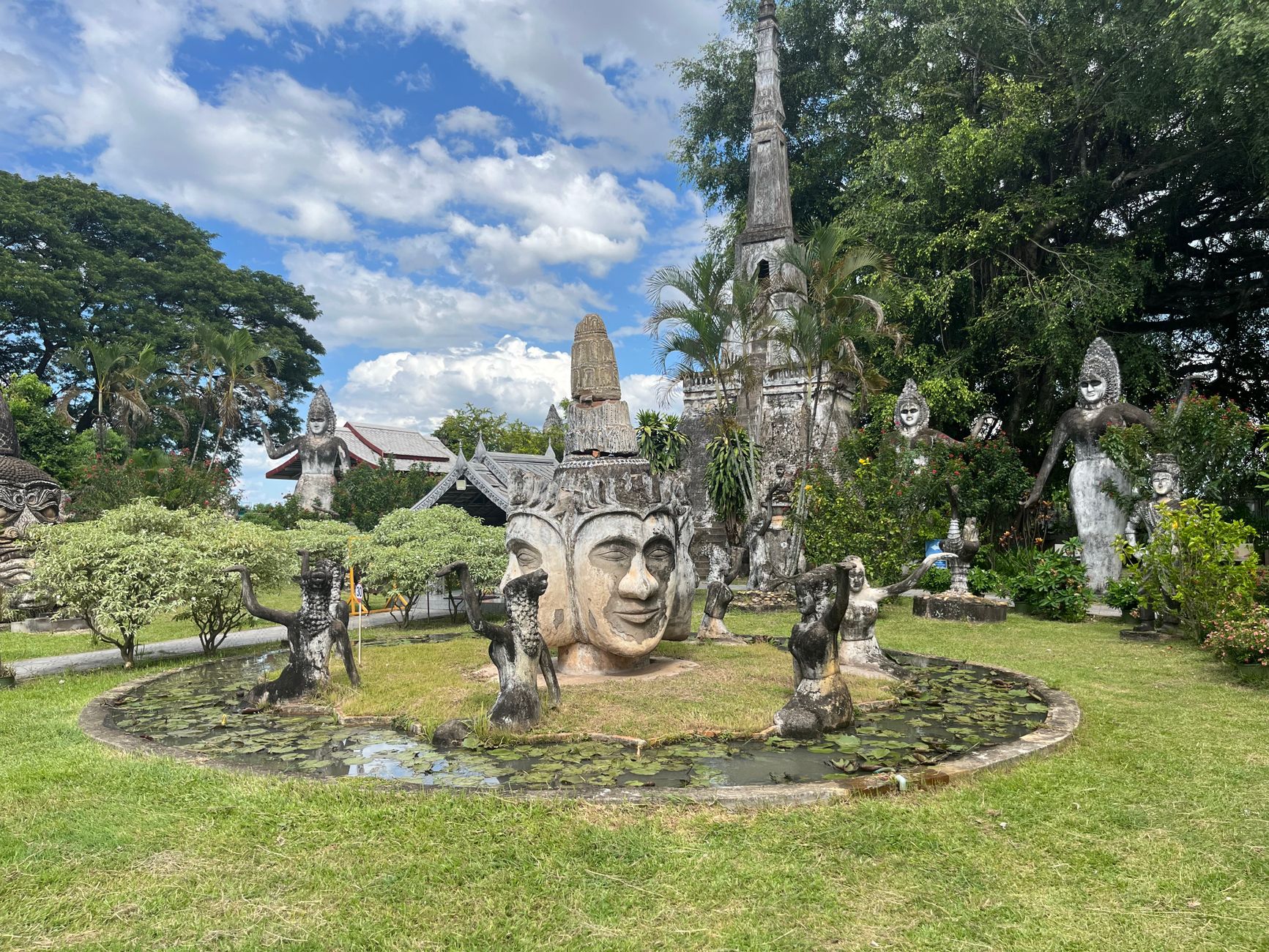 Vientiane, Laos — stone sculptures at Xieng Khuan Buddha Park under a blue sky
